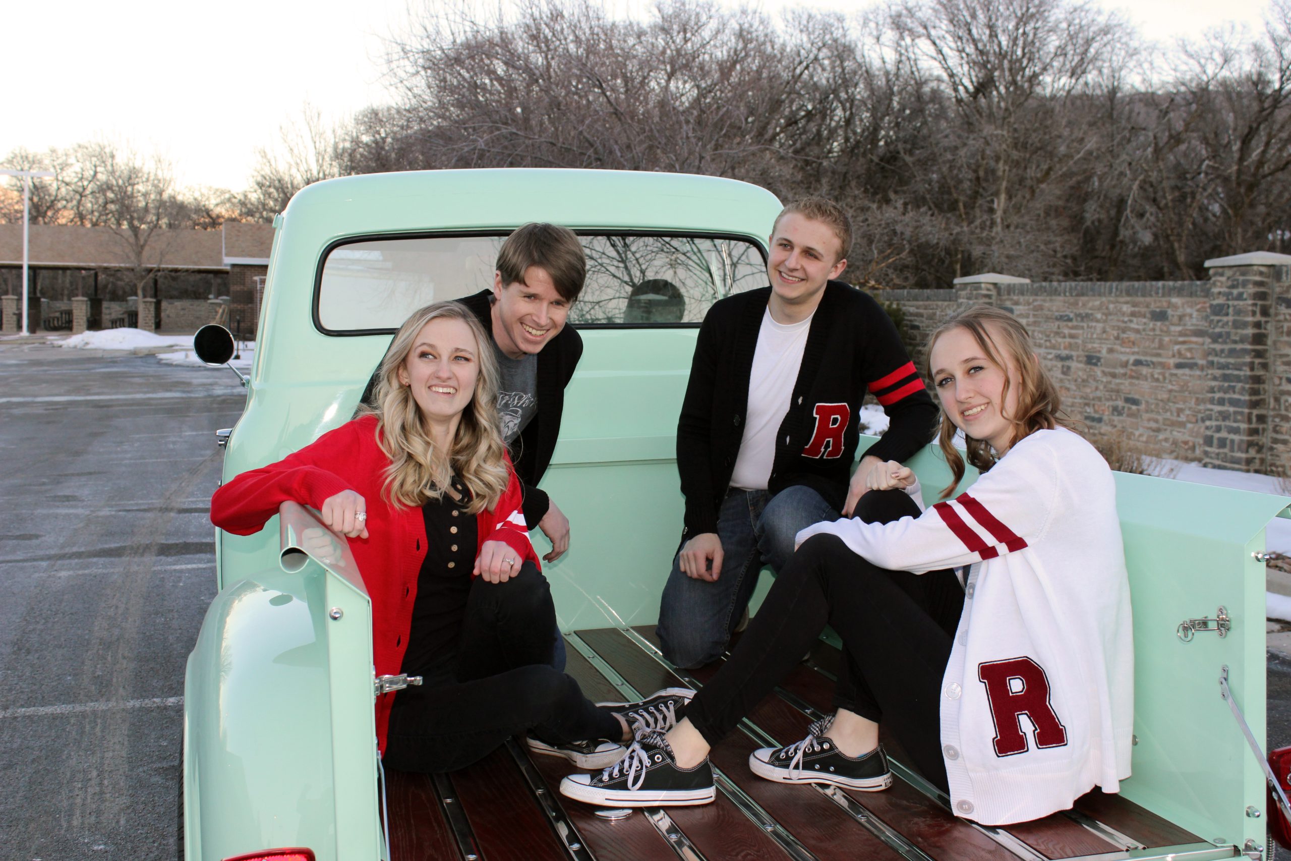 IMG_5044w 1956 Ford Truck mint green with family sitting in the back wearing 1950's varsity letterman sweaters for men and women.